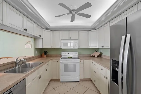 a kitchen with stainless steel appliances granite countertop a refrigerator and a cabinets