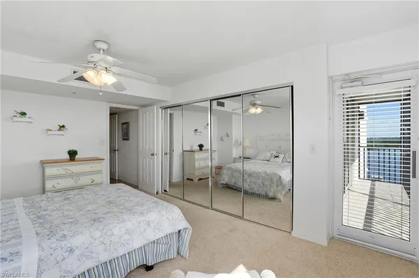 a bedroom with bed and a potted plant