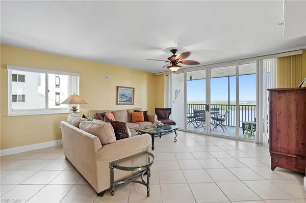 a dining hall with stainless steel appliances a dining table and chairs