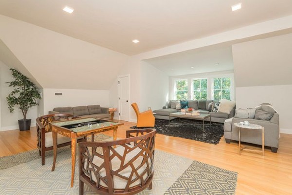175 Coolidge Hill Road Cambridge, MA 02138 - Photo 21 of 25 a living room with furniture a dining table and a stove with wooden floor