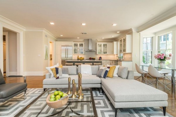 175 Coolidge Hill Road Cambridge, MA 02138 - Photo 6 of 25 a living room with white couches and a dining table with kitchen view