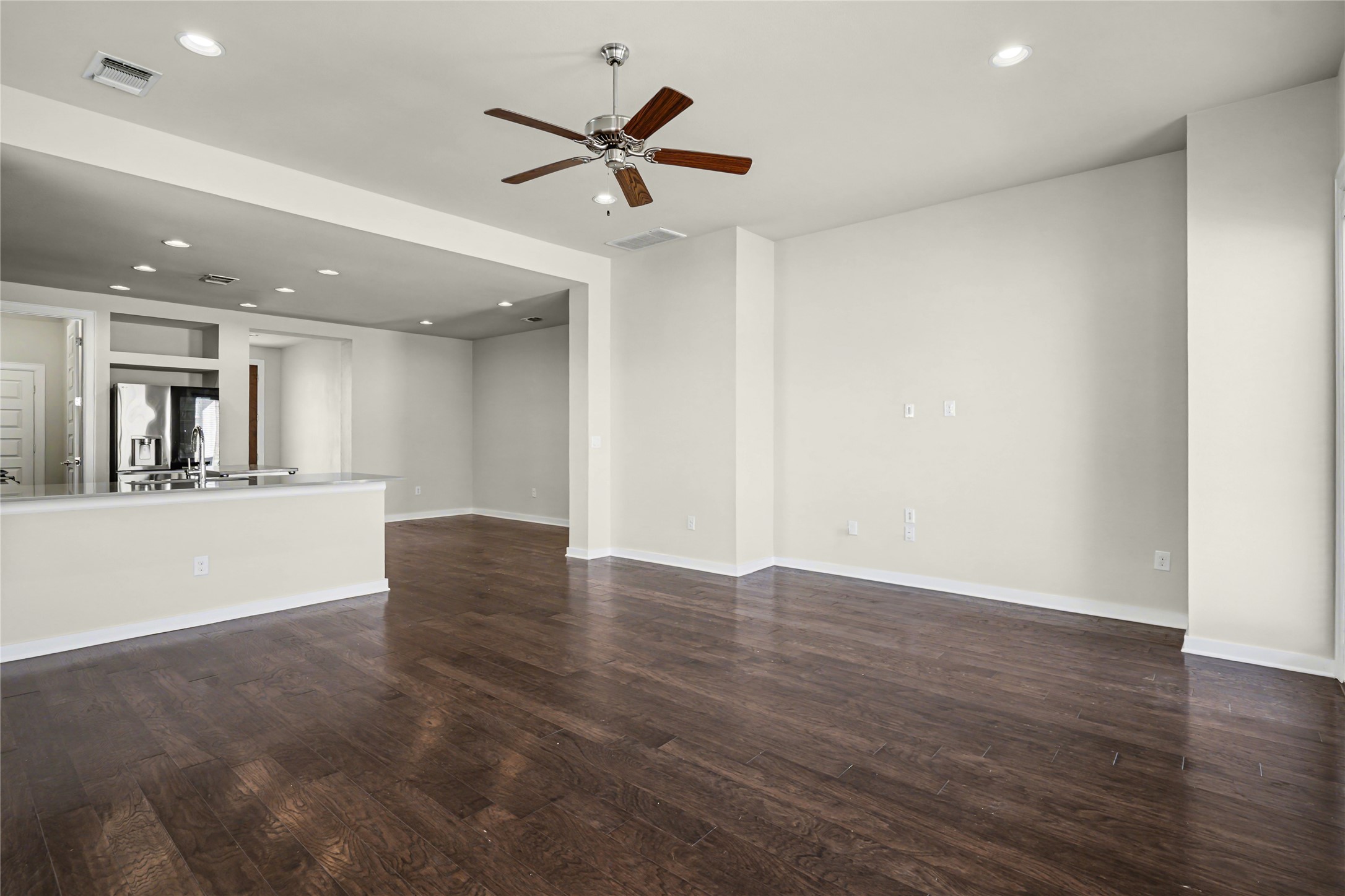 7216 Cherry Beam Path Austin, TX 78744 - Photo 12 of 32 an empty room with wooden floor and windows