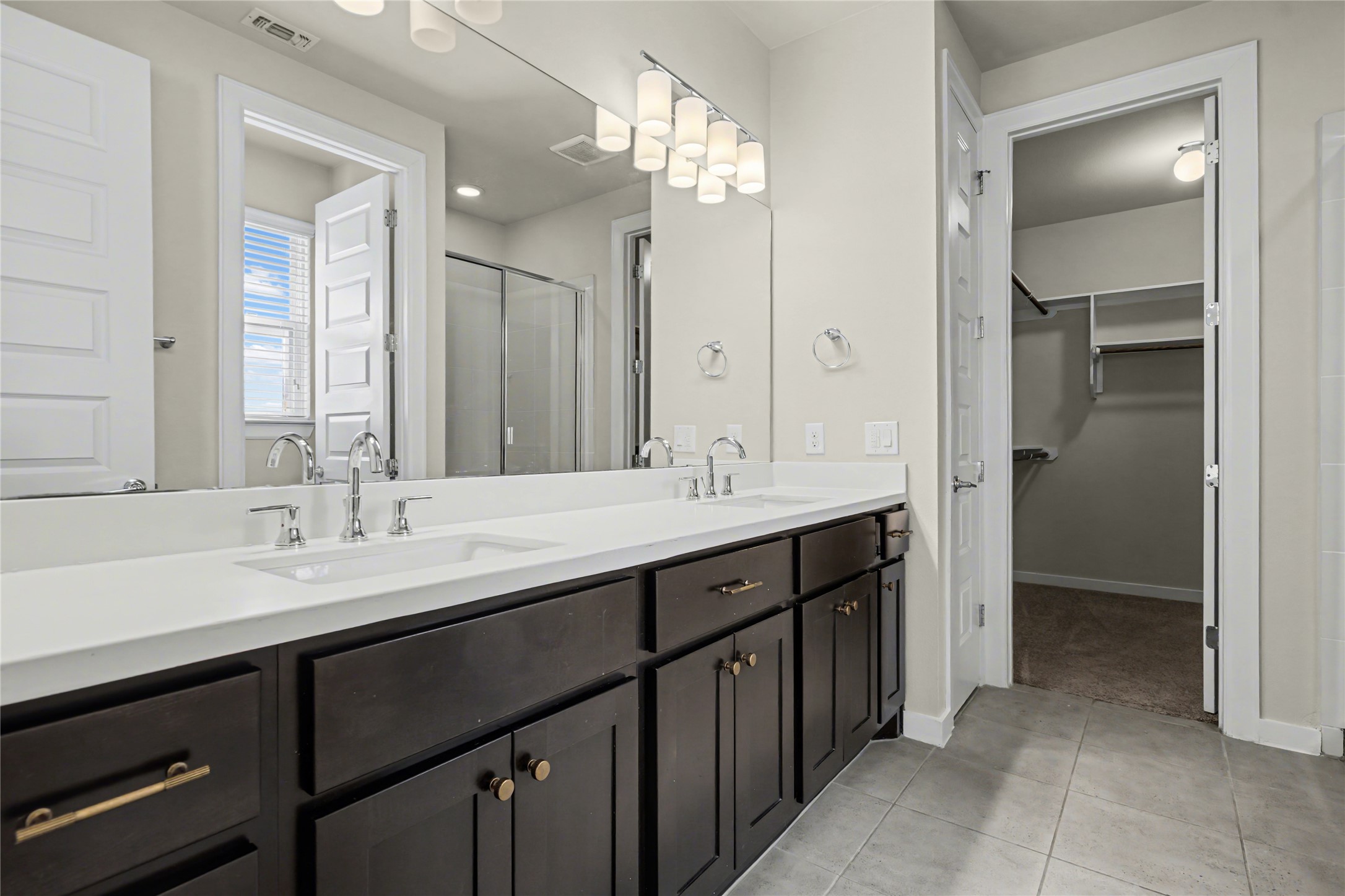 7216 Cherry Beam Path Austin, TX 78744 - Photo 15 of 32 a bathroom with a double vanity sink and a mirror