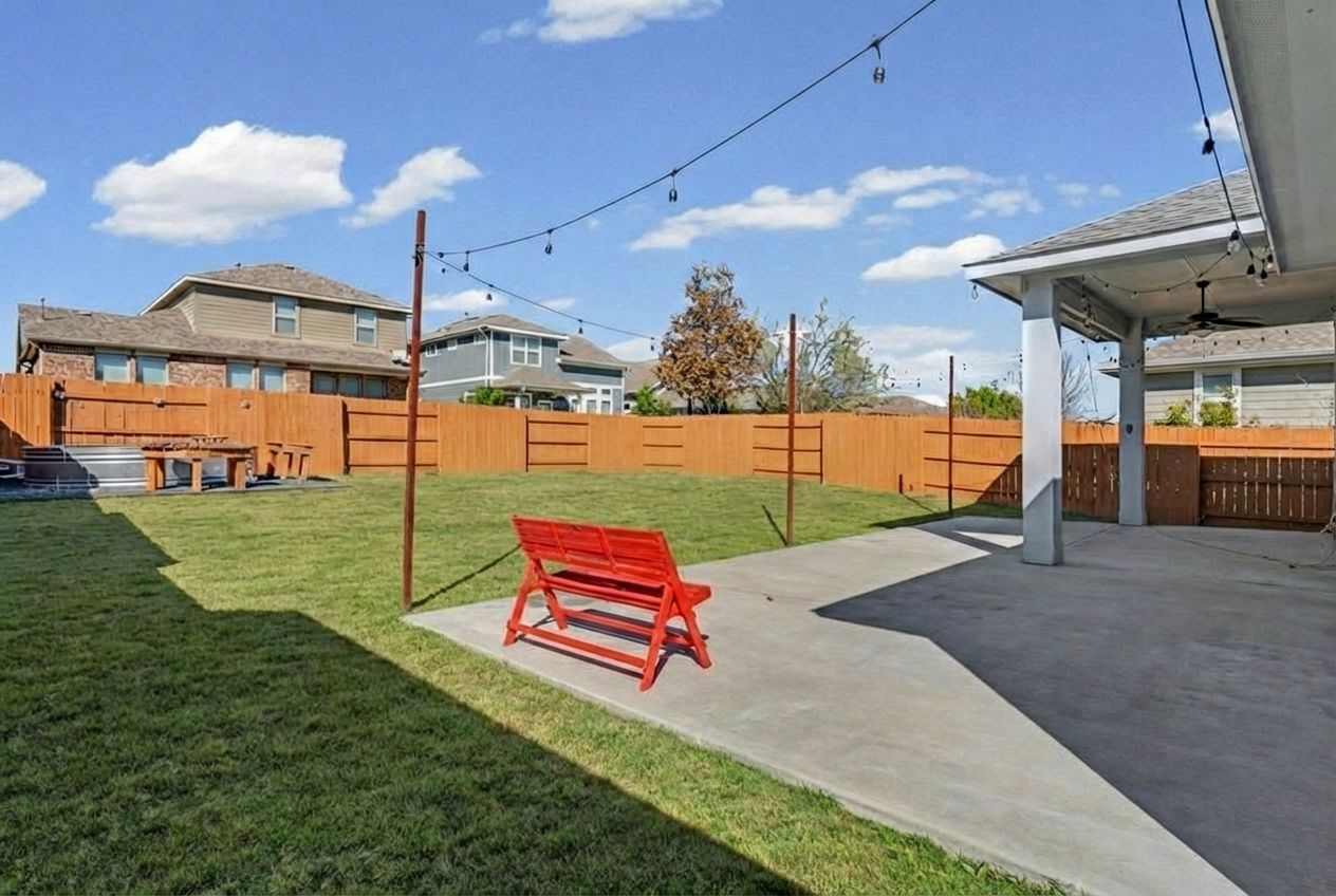 7216 Cherry Beam Path Austin, TX 78744 - Photo 19 of 32 a backyard of a house with swimming pool table and chairs