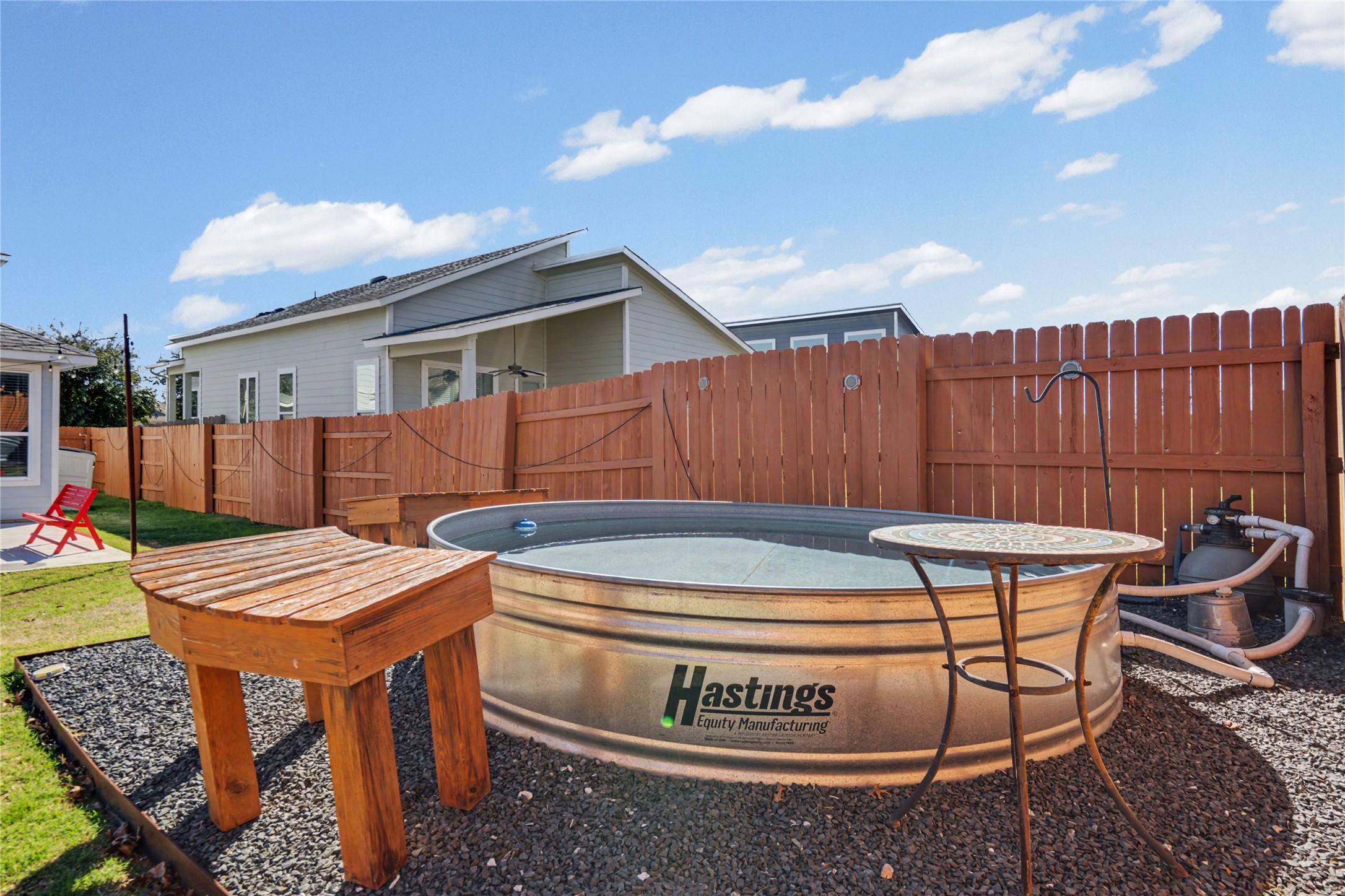 7216 Cherry Beam Path Austin, TX 78744 - Photo 20 of 32 a view of a chairs and tables in the back yard of the house