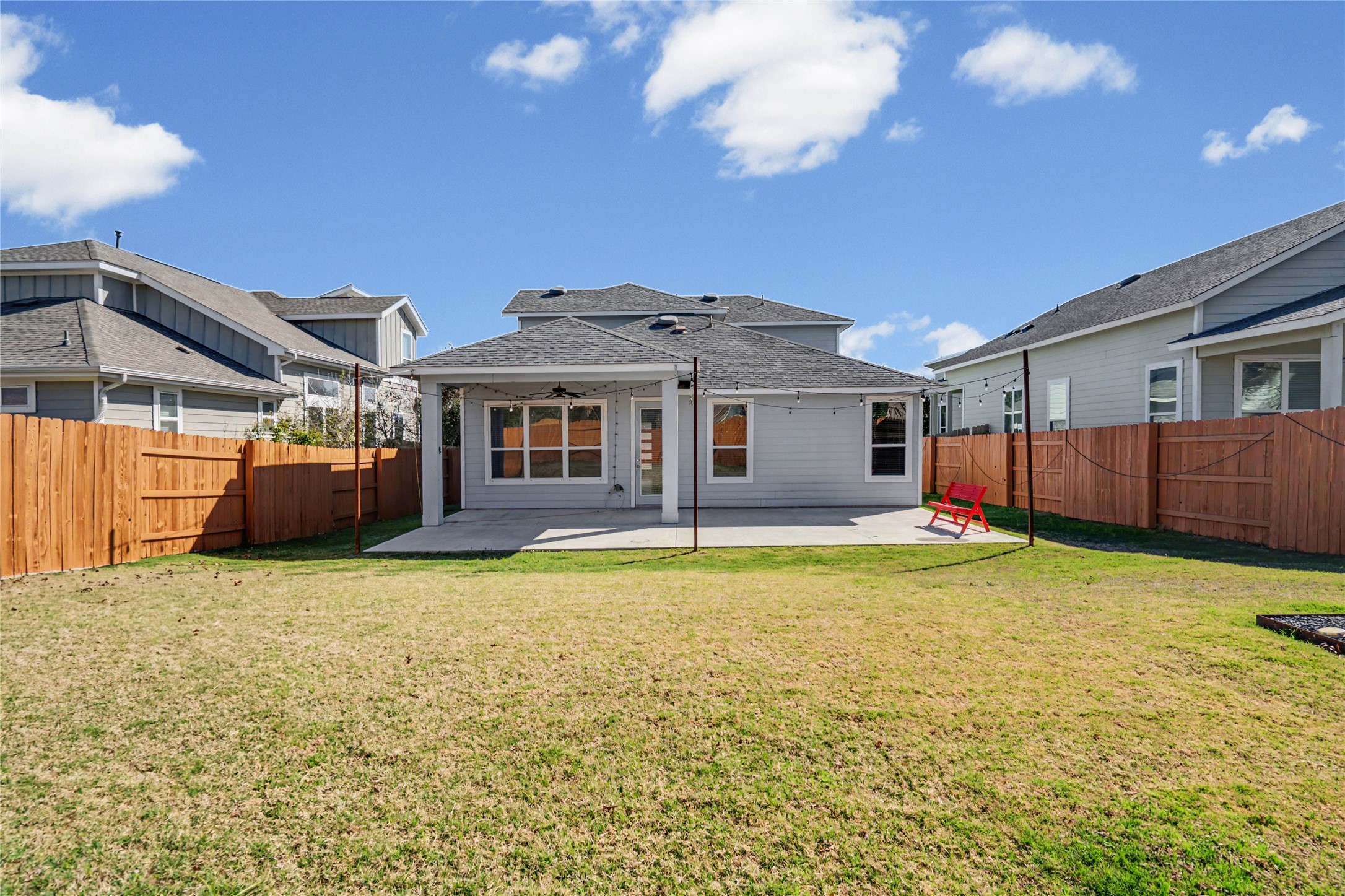 7216 Cherry Beam Path Austin, TX 78744 - Photo 21 of 32 a front view of a house with a garden and yard