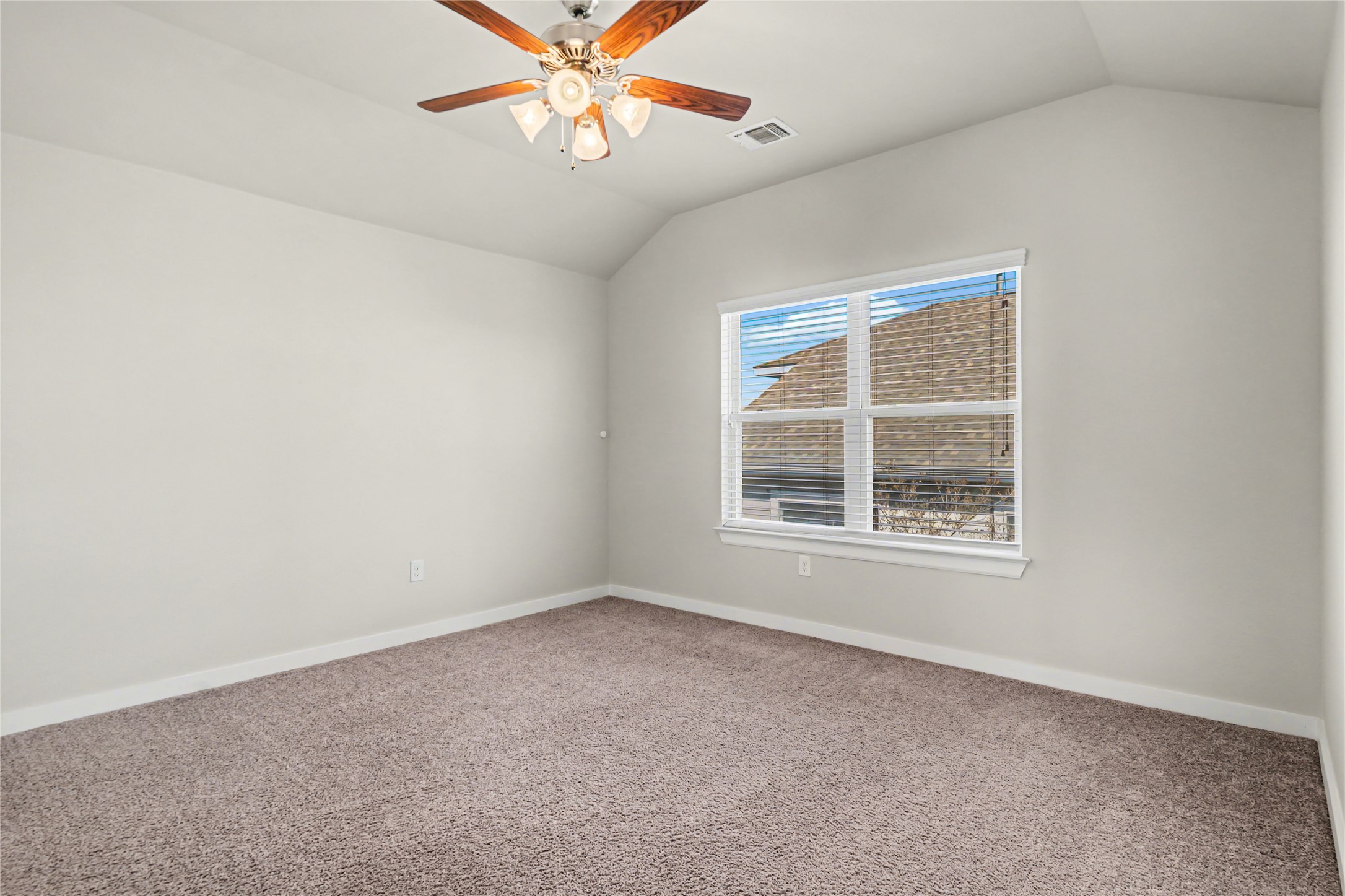 7216 Cherry Beam Path Austin, TX 78744 - Photo 26 of 32 an empty room with a window and a fan