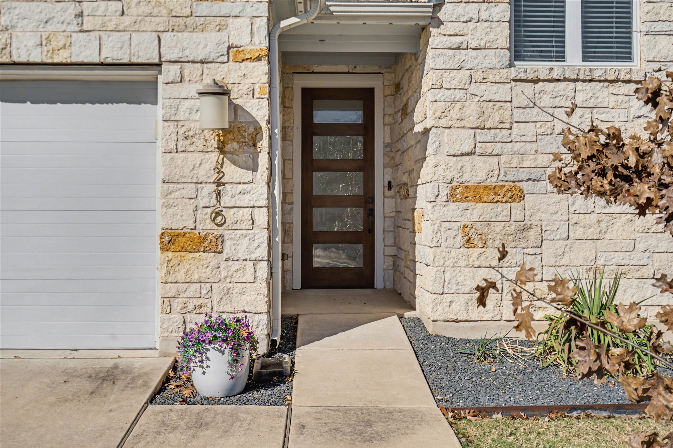 7216 Cherry Beam Path Austin, TX 78744 - Photo 3 of 32 a front view of a house with an outdoor space