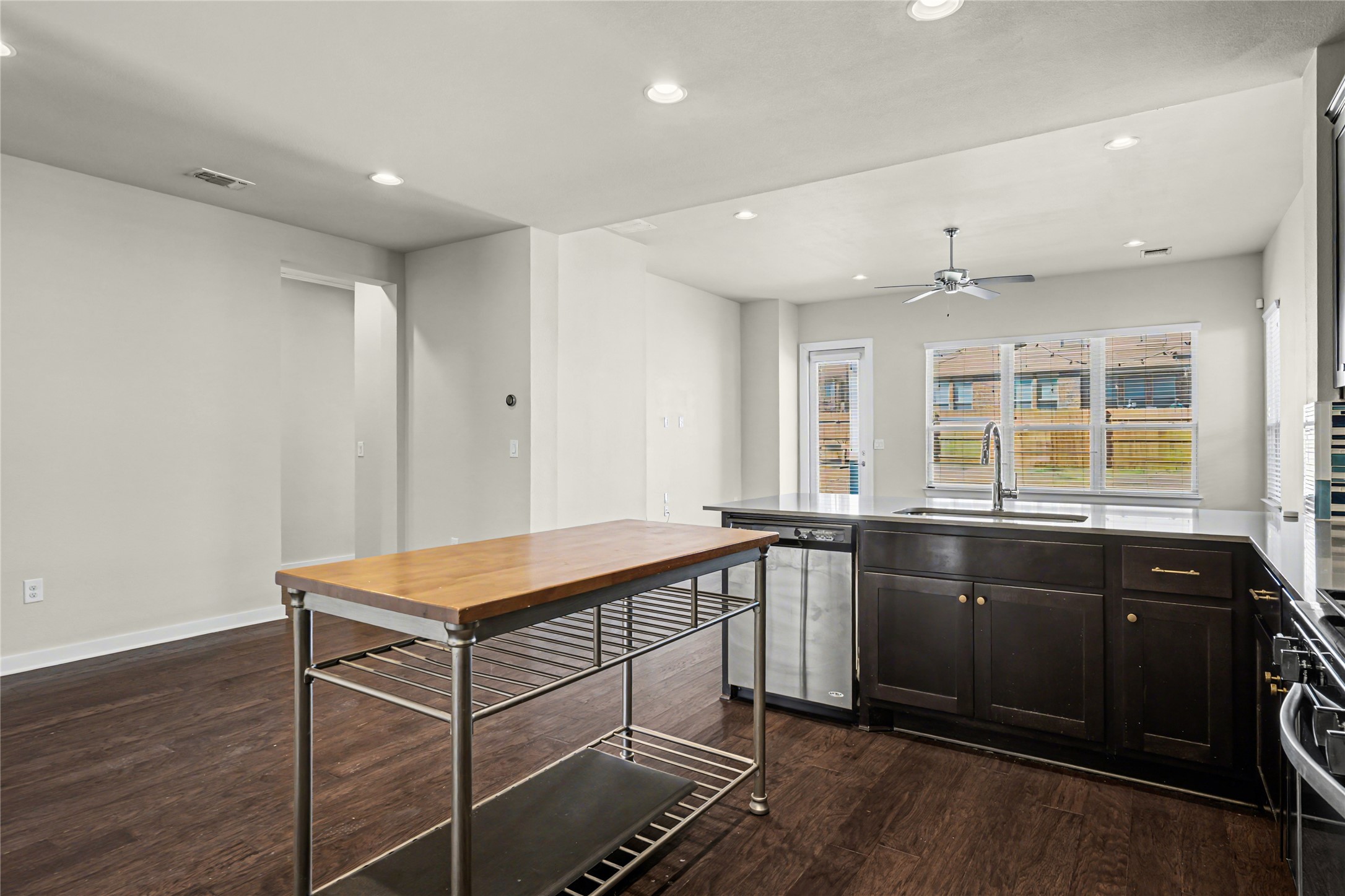 7216 Cherry Beam Path Austin, TX 78744 - Photo 8 of 32 a kitchen with a sink and wooden cabinets
