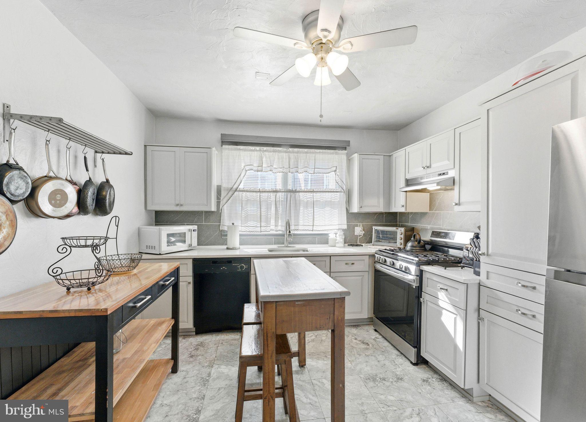 7828 Michener Avenue Philadelphia, PA 19150 - Photo 1 of 23 a kitchen with cabinets a sink and stainless steel appliances