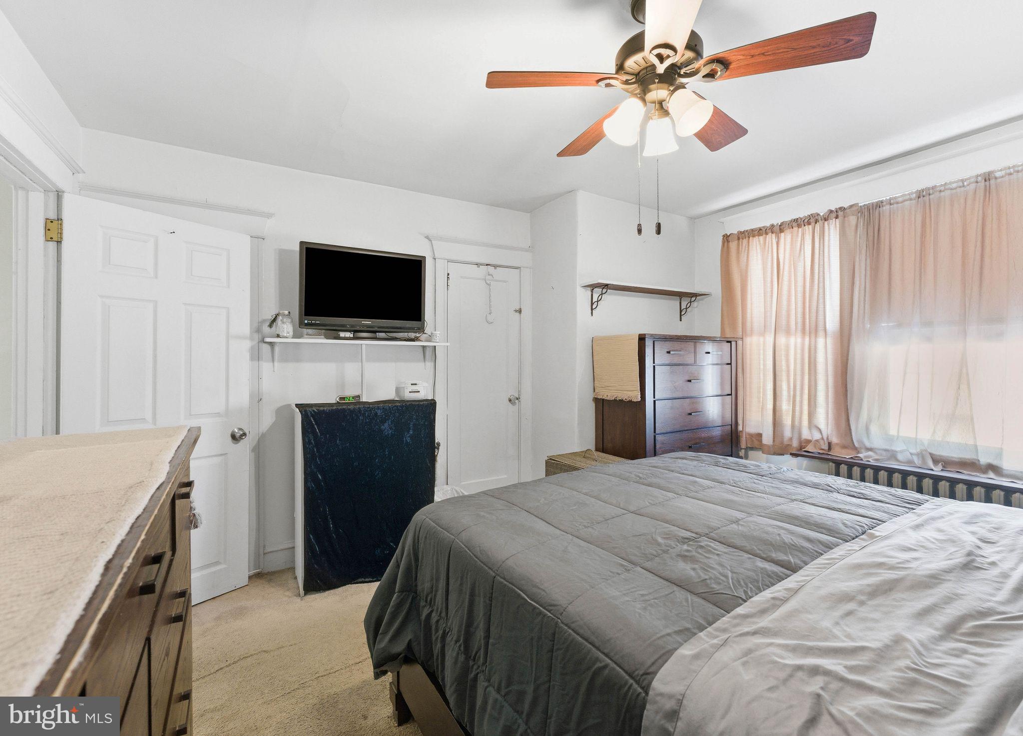 7828 Michener Avenue Philadelphia, PA 19150 - Photo 14 of 23 a bedroom with a bed and a flat screen tv