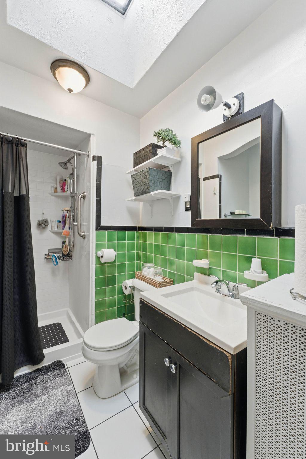 7828 Michener Avenue Philadelphia, PA 19150 - Photo 17 of 23 a bathroom with a sink a toilet and mirror