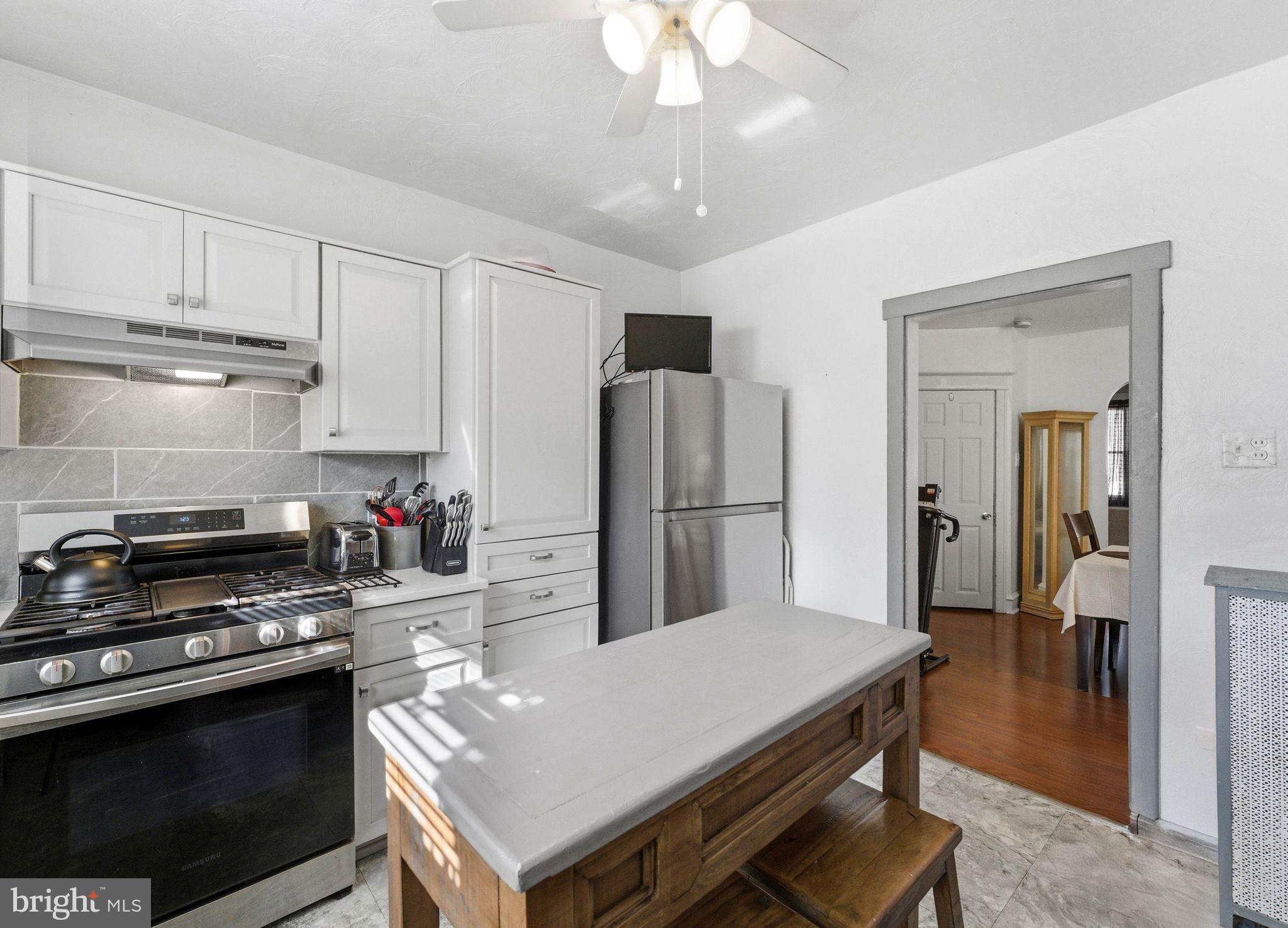 7828 Michener Avenue Philadelphia, PA 19150 - Photo 10 of 23 a kitchen with a stove a refrigerator and a sink