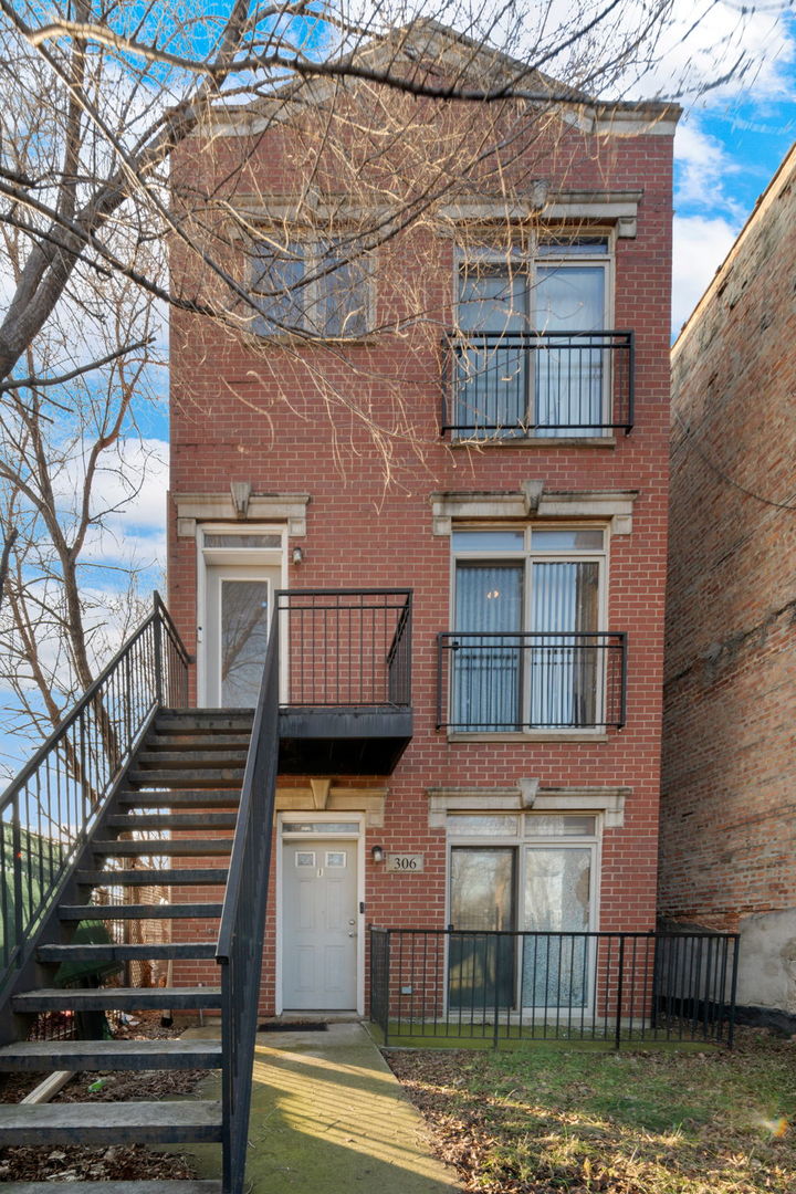306 North Hamlin Avenue, Unit 1 Chicago, IL 60624 - Photo 1 of 16 a front view of a house with a yard