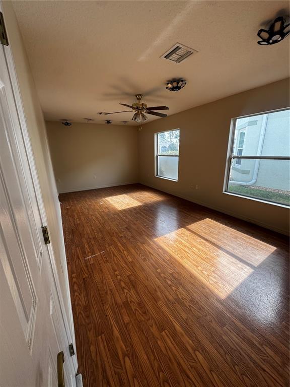 15296 Southwest 15th Terrace Road Ocala, FL 34473 - Photo 12 of 15 wooden floor in an empty room with a window