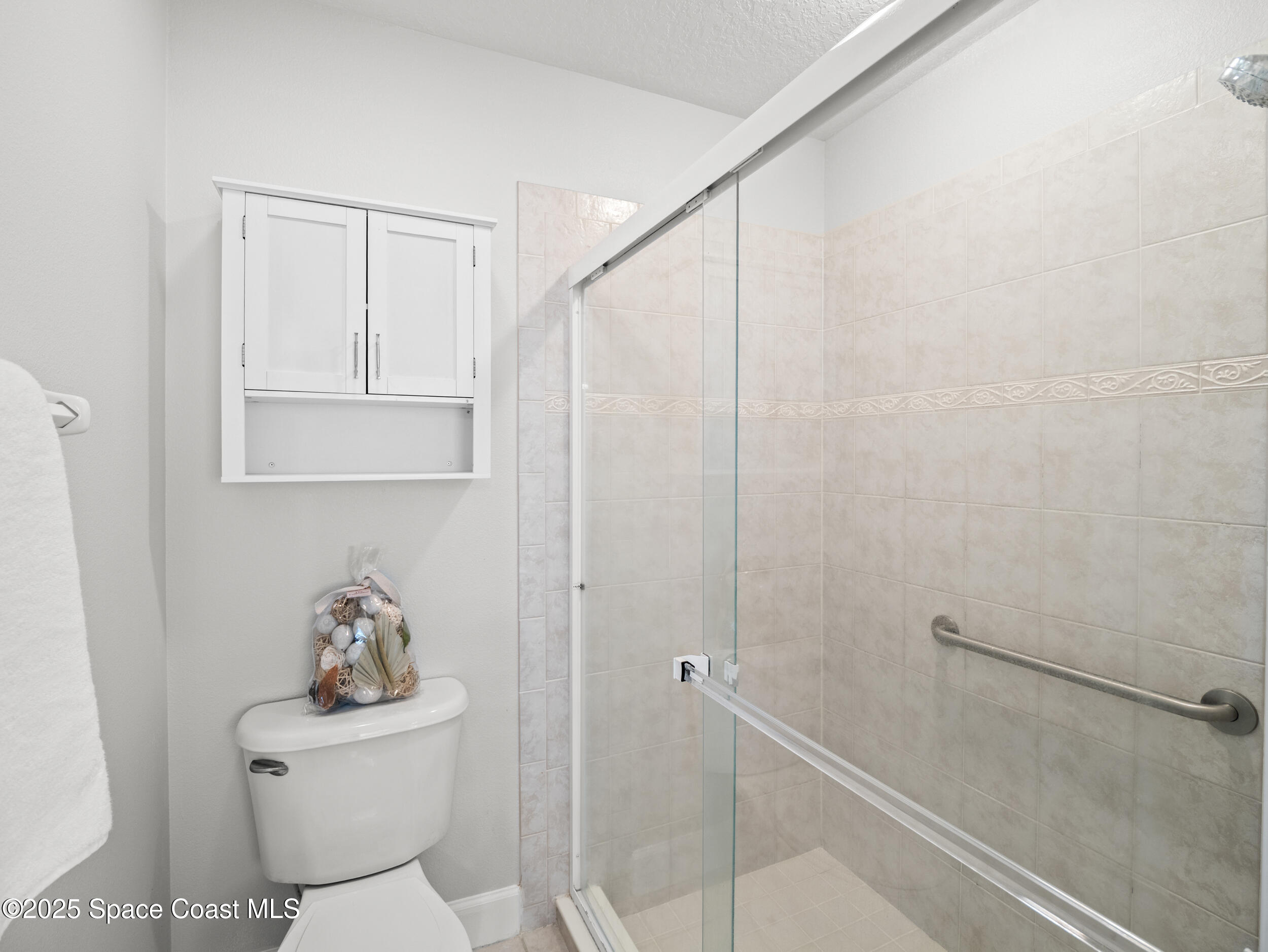 5015 Pinot Street Rockledge, FL 32955 - Photo 22 of 46 a bathroom with a toilet a sink and shower