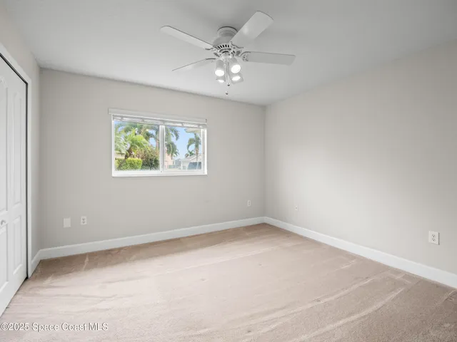 a view of a big house with a big yard and large trees