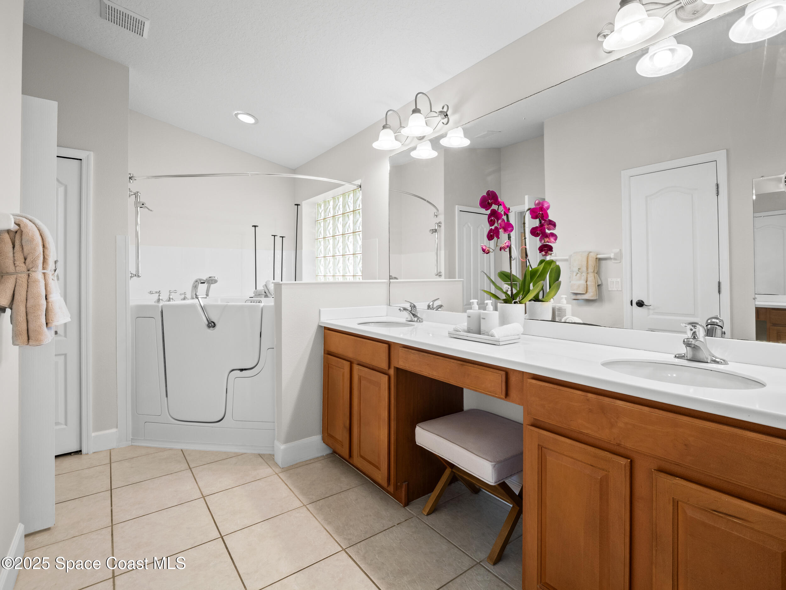 5015 Pinot Street Rockledge, FL 32955 - Photo 29 of 46 a spacious bathroom with a sink a large mirror and a shower