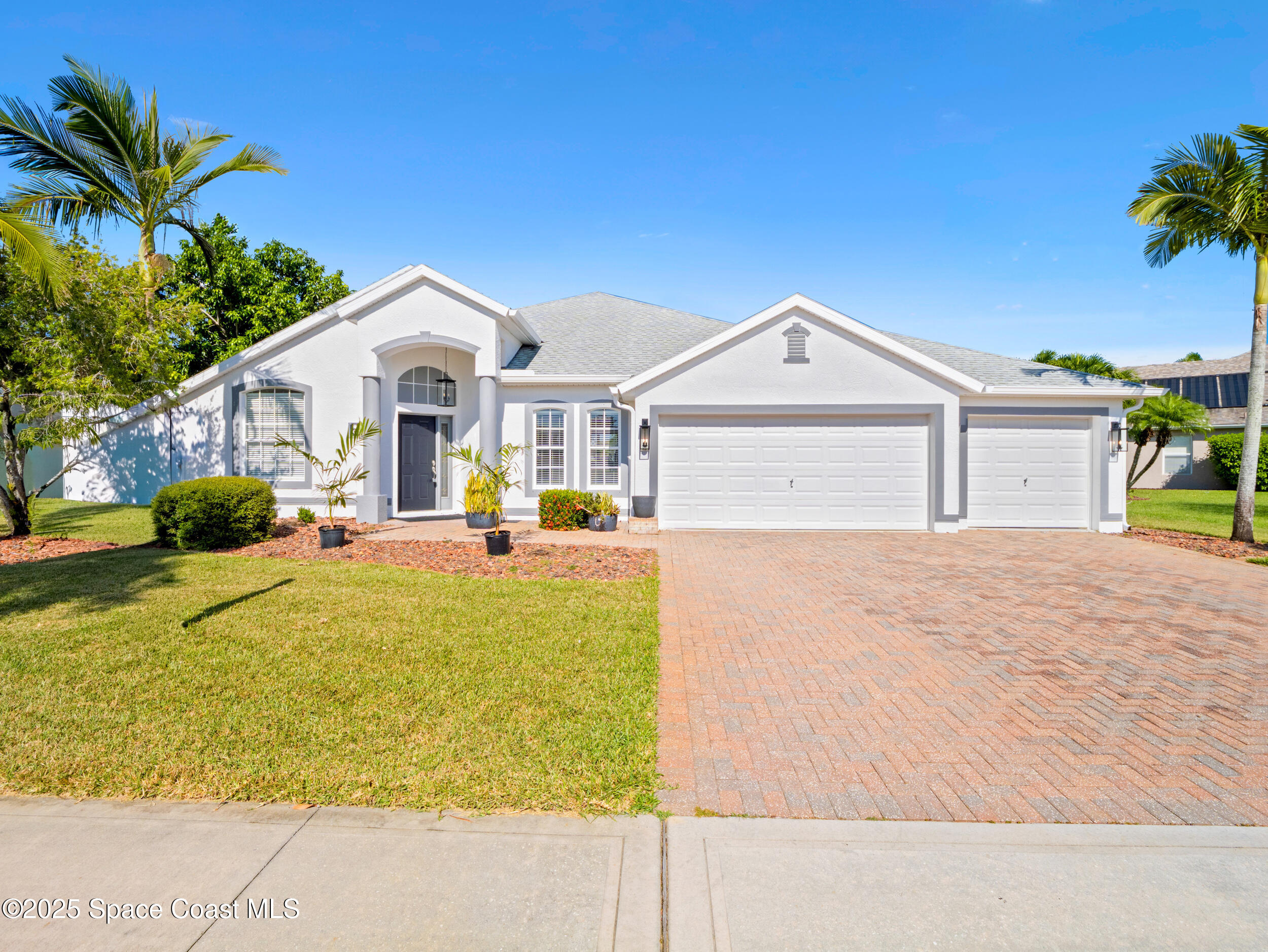 5015 Pinot Street Rockledge, FL 32955 - Photo 3 of 46 a front view of a house with a yard outdoor outdoor seating and garage