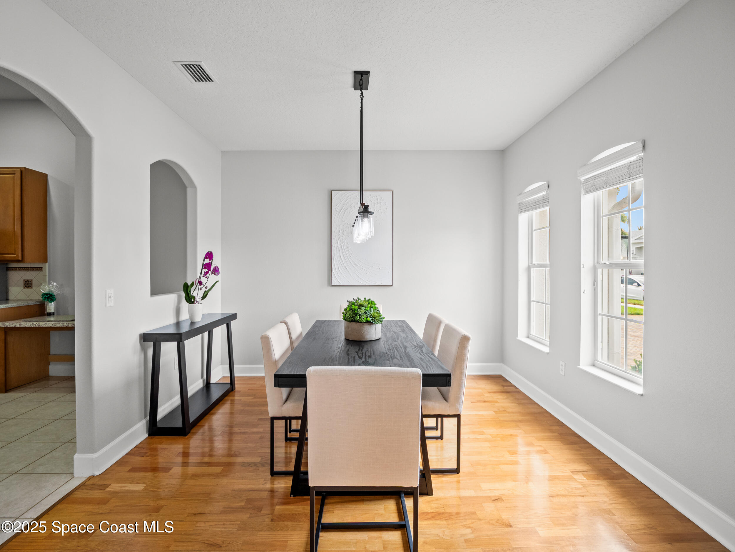 5015 Pinot Street Rockledge, FL 32955 - Photo 10 of 46 a dining room with furniture a rug a potted plant and wooden floor
