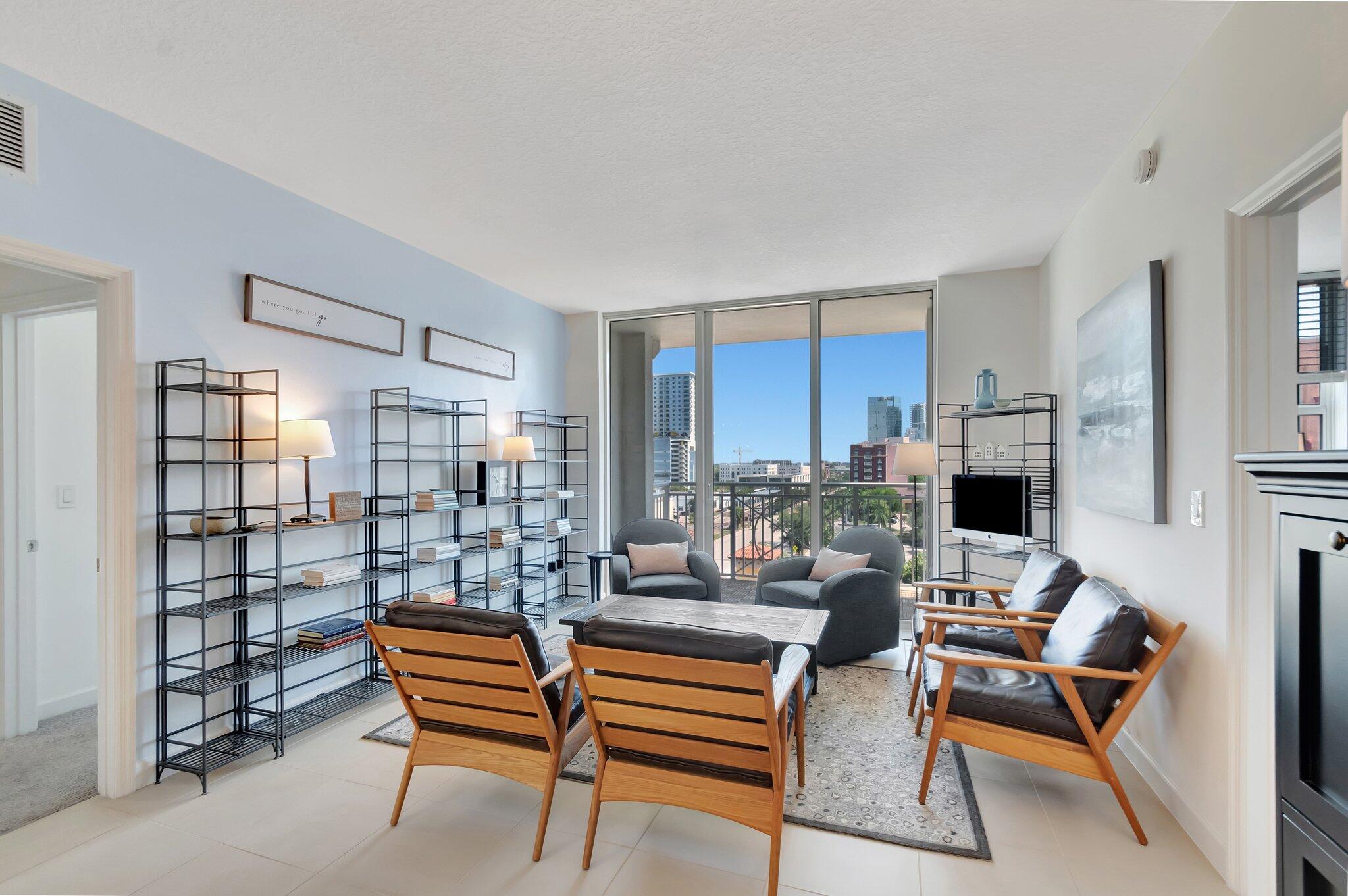 480 Hibiscus Street, Unit 709 West Palm Beach, FL 33401 - Photo 11 of 39 a work room with furniture and a flat screen tv