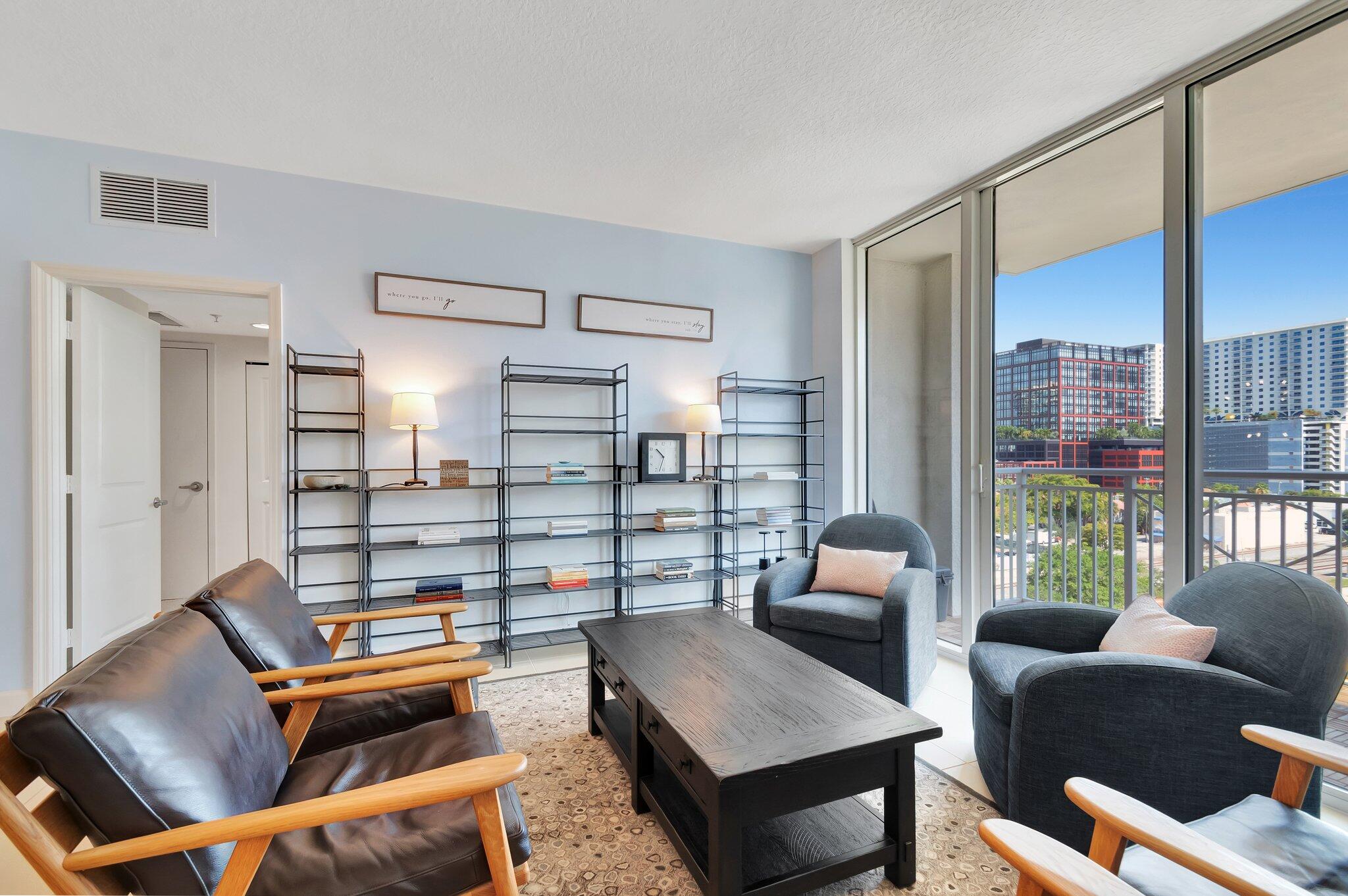 480 Hibiscus Street, Unit 709 West Palm Beach, FL 33401 - Photo 12 of 39 a living room with furniture a rug and a large window