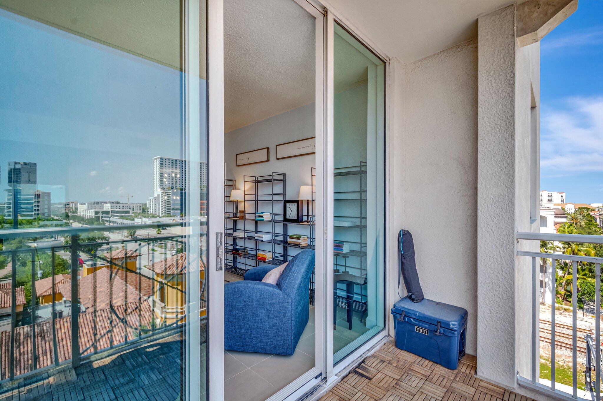 480 Hibiscus Street, Unit 709 West Palm Beach, FL 33401 - Photo 15 of 39 a balcony with wooden floor table and chairs