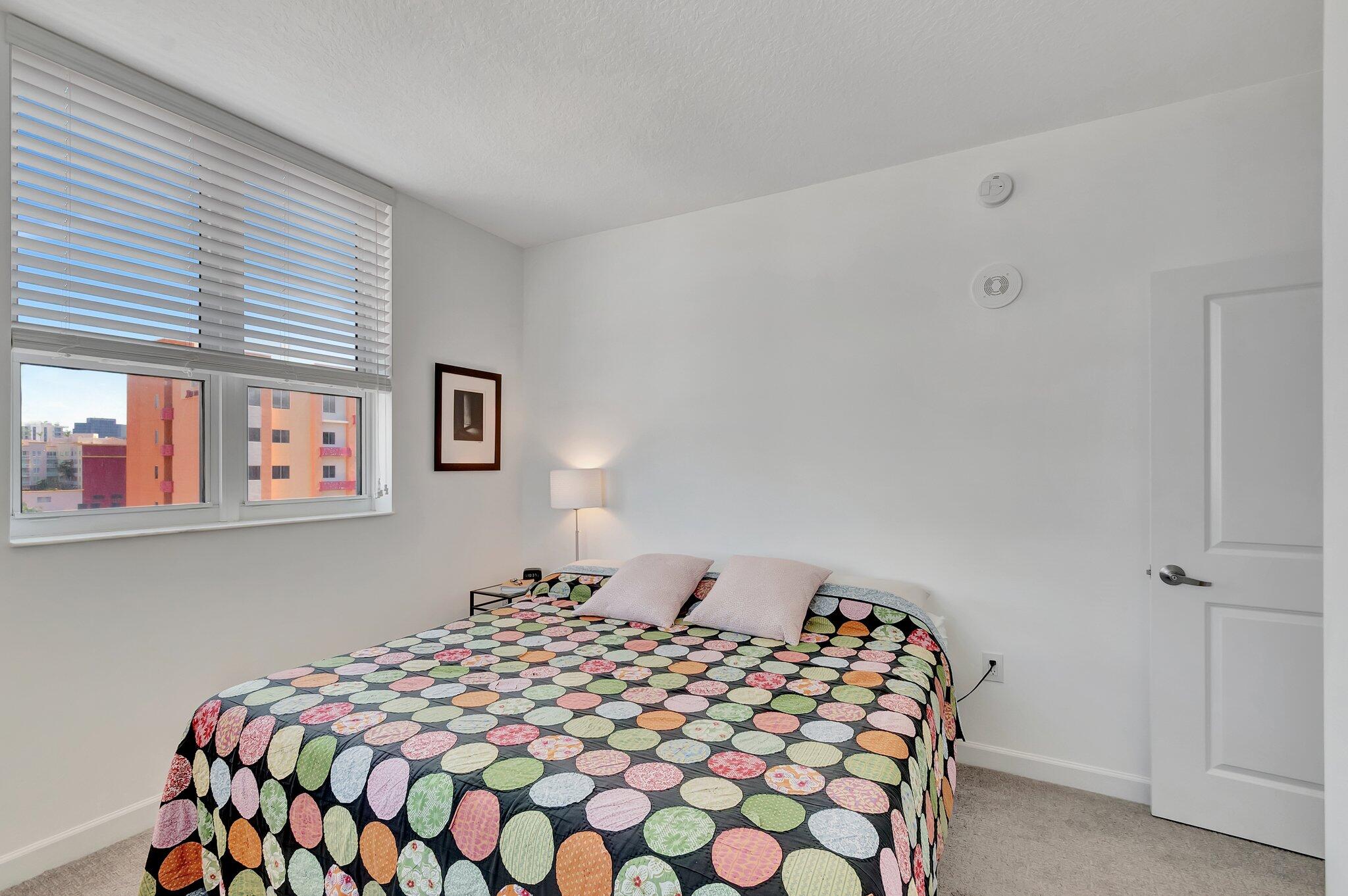 480 Hibiscus Street, Unit 709 West Palm Beach, FL 33401 - Photo 19 of 39 a bedroom with a bed and dresser with window