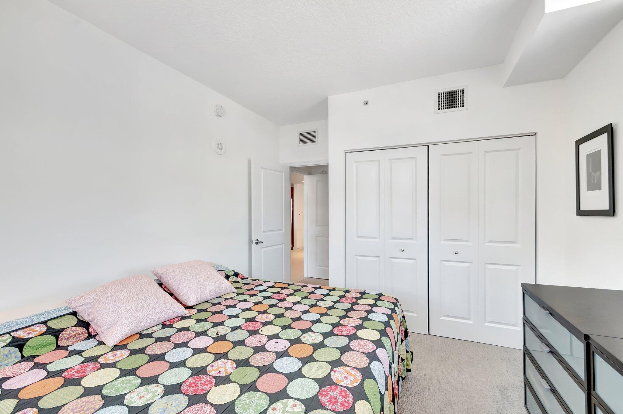 480 Hibiscus Street, Unit 709 West Palm Beach, FL 33401 - Photo 20 of 39 a bedroom with a bed and a lamp