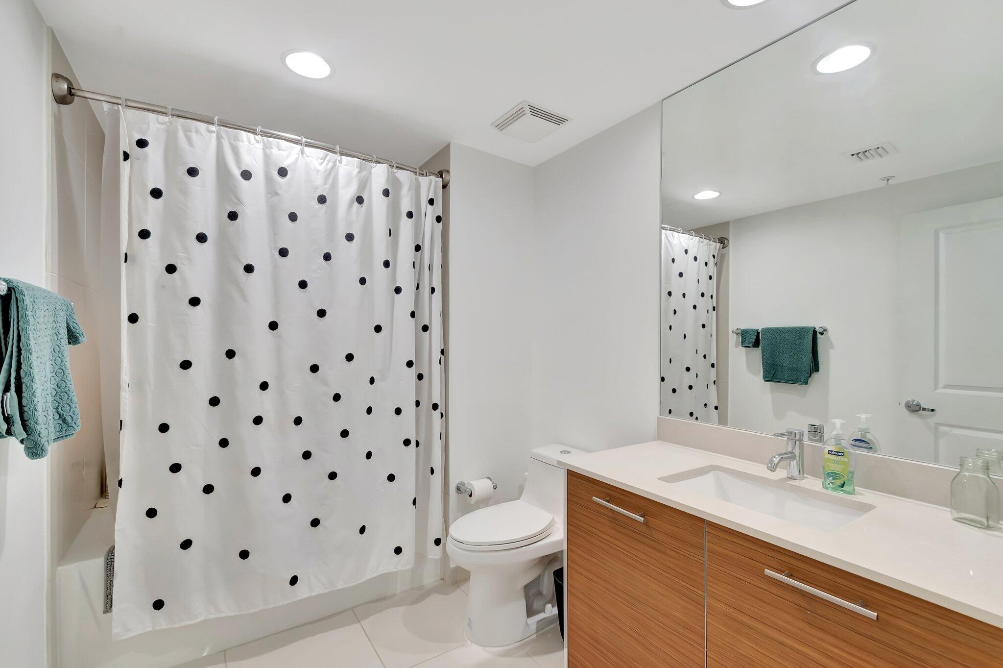 480 Hibiscus Street, Unit 709 West Palm Beach, FL 33401 - Photo 21 of 39 a bathroom with a sink toilet and shower