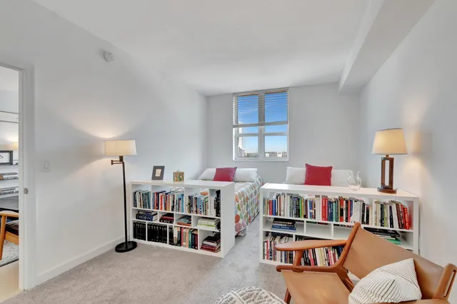 a bedroom with two beds and a baby crib