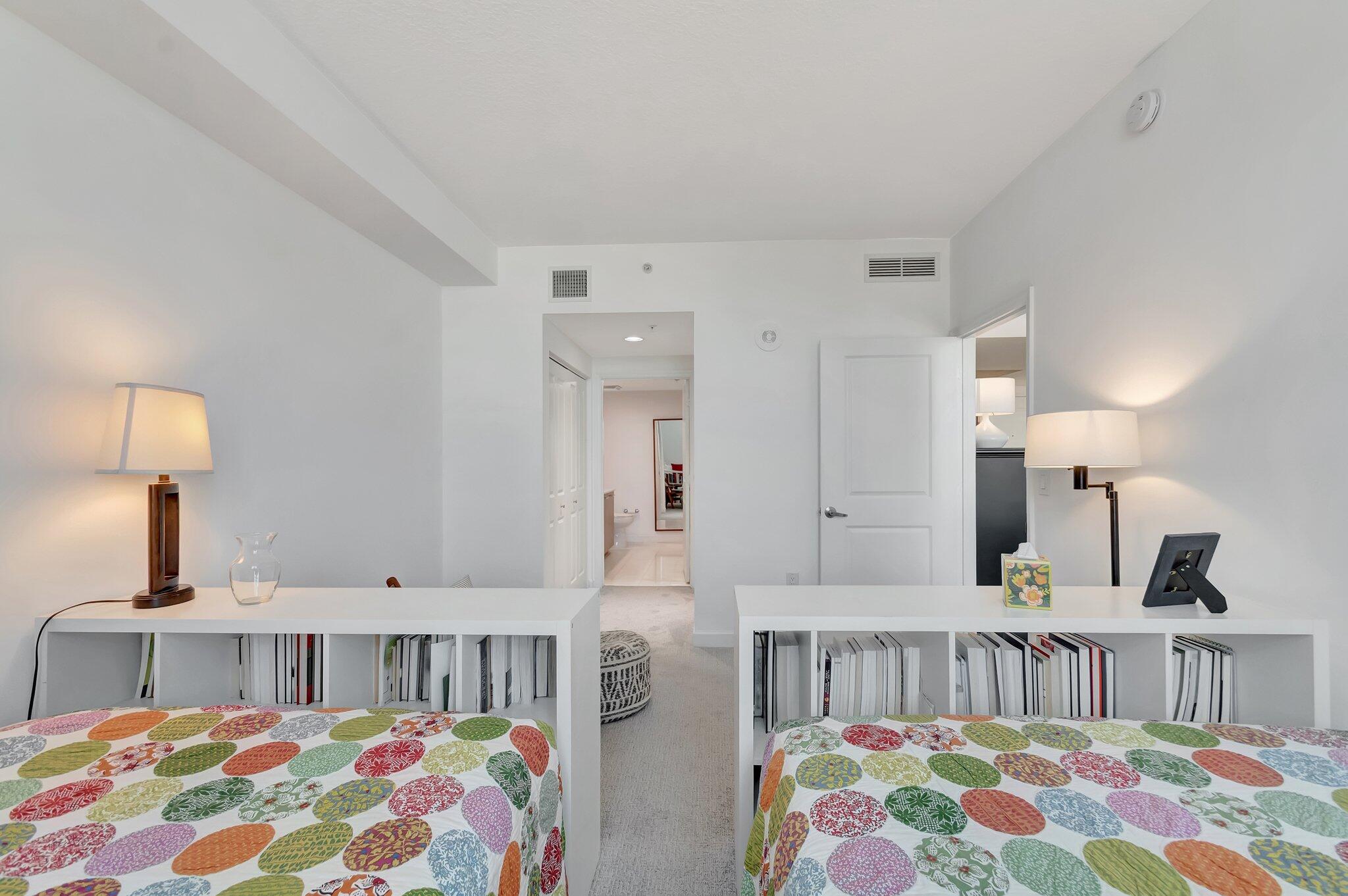 480 Hibiscus Street, Unit 709 West Palm Beach, FL 33401 - Photo 24 of 39 a bedroom with two beds and a baby crib