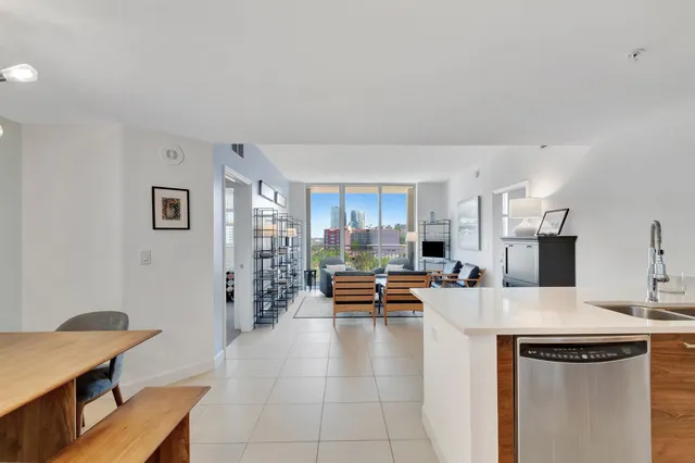 a kitchen with stainless steel appliances kitchen island granite countertop a sink and cabinets