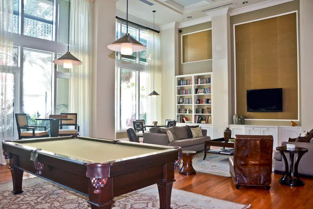 a living room with furniture and a floor to ceiling window