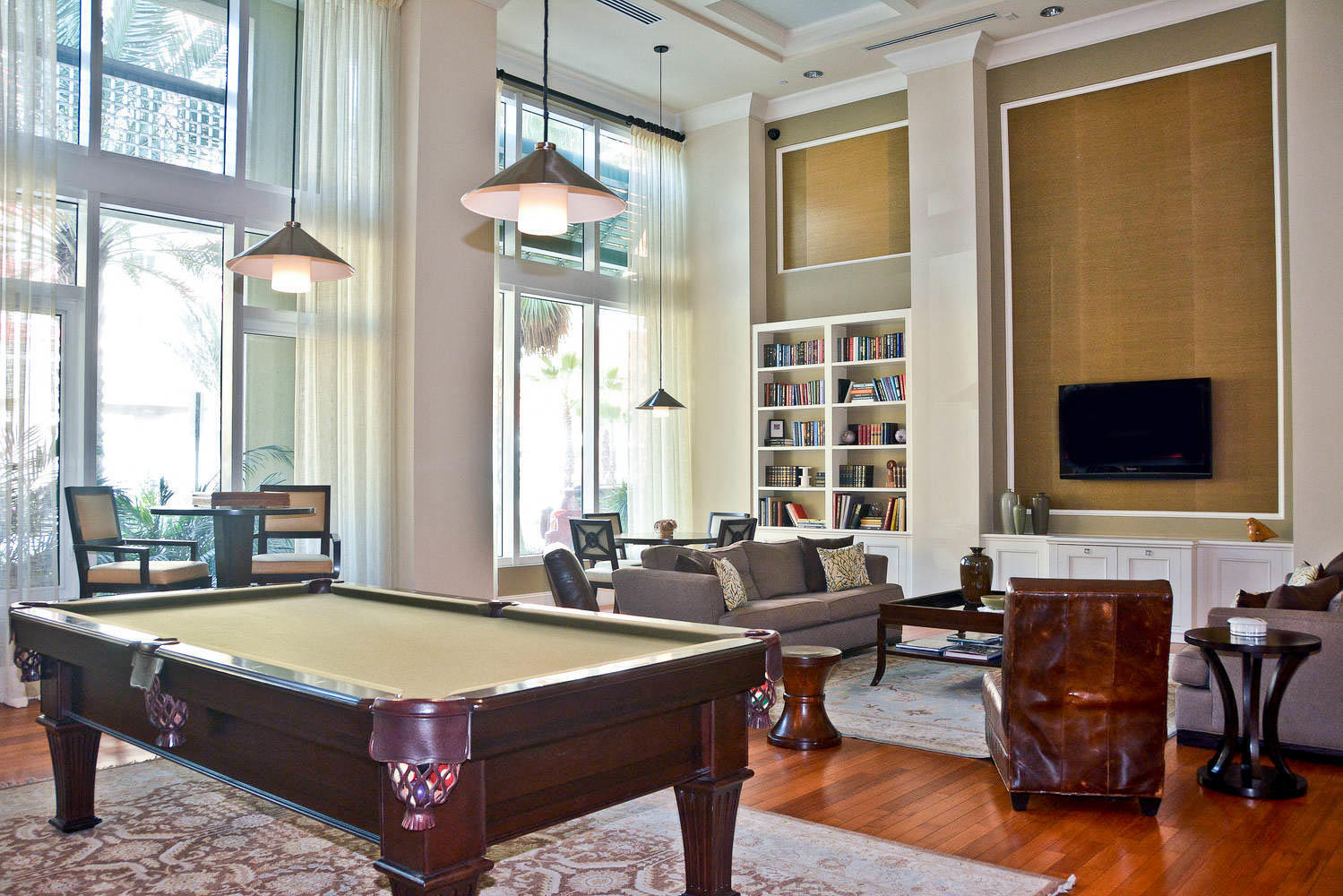 480 Hibiscus Street, Unit 709 West Palm Beach, FL 33401 - Photo 34 of 39 a living room with furniture pool table and large windows