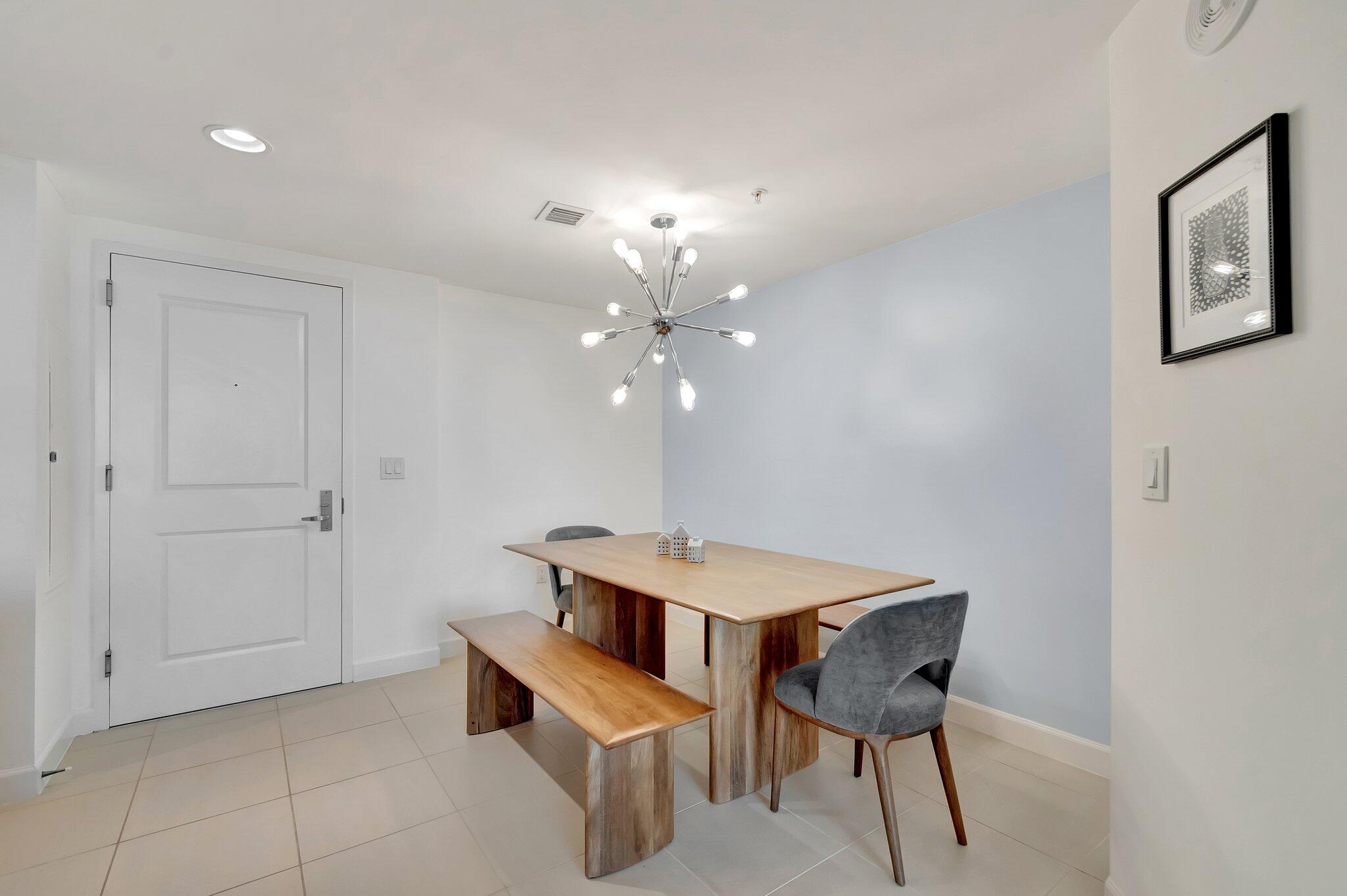 480 Hibiscus Street, Unit 709 West Palm Beach, FL 33401 - Photo 5 of 39 a view of a dining room with furniture and chandelier
