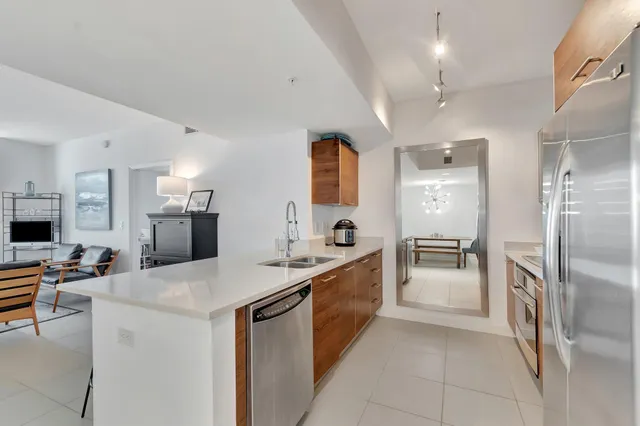 a kitchen that has a lot of cabinets a sink and appliances in it