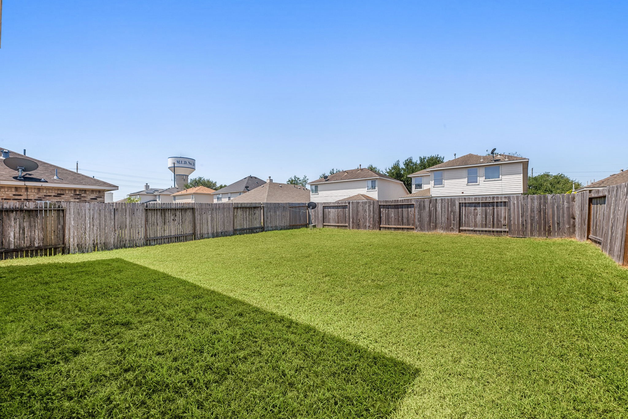 20927 Roxette Court Humble, TX 77338 - Photo 16 of 19 The fully fenced backyard offers a spacious, level lawn with plenty of room to enjoy outdoors.