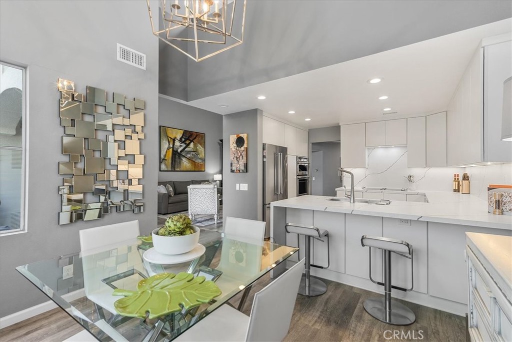 4 Logo Vista Dana Point, CA 92629 - Photo 16 of 44 a living room with stainless steel appliances furniture a rug and a kitchen view