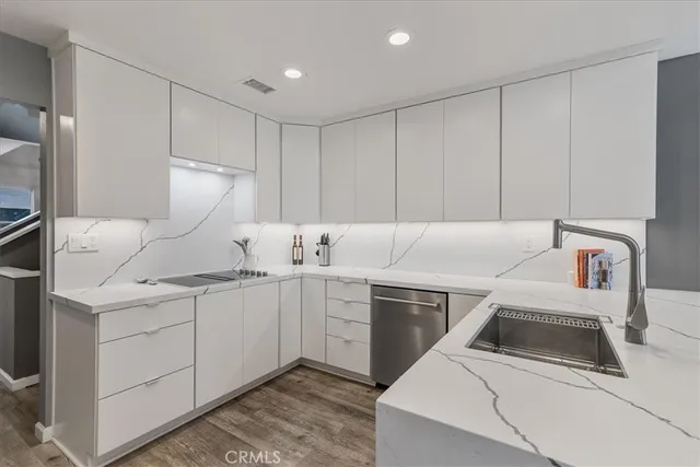 a kitchen with a sink cabinets and appliances