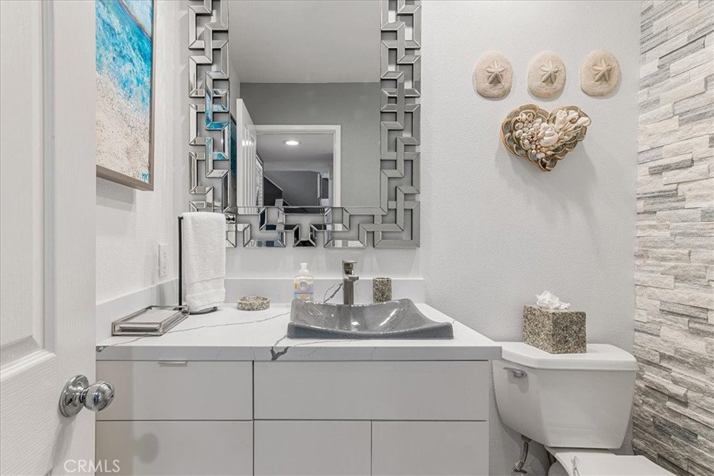 4 Logo Vista Dana Point, CA 92629 - Photo 19 of 44 a bathroom with a toilet sink and mirror
