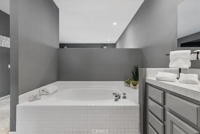 a bathroom with a bathtub and a sink