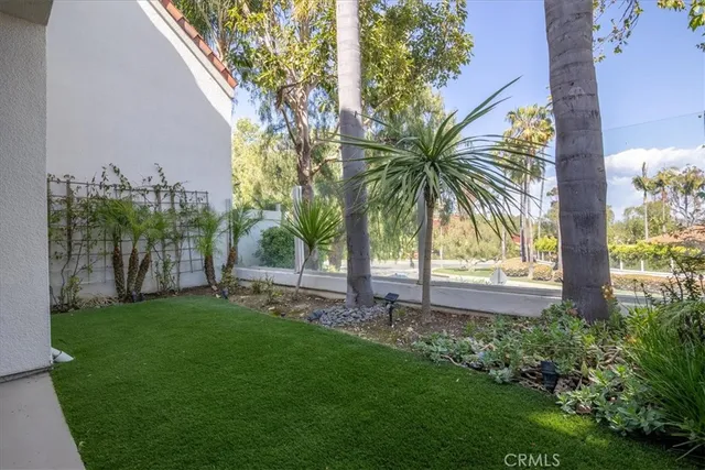 a garden with trees in front of it