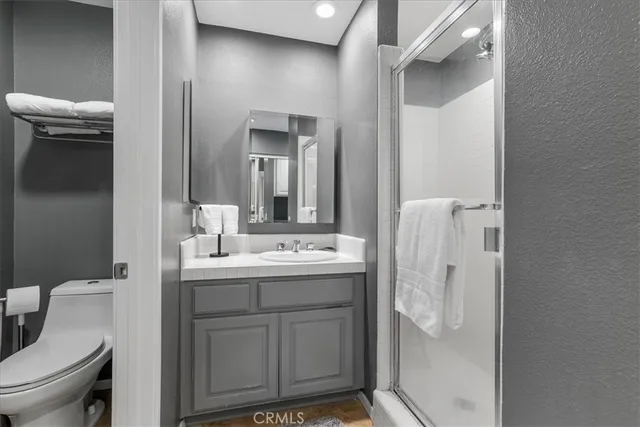 a bathroom with a sink a toilet and shower