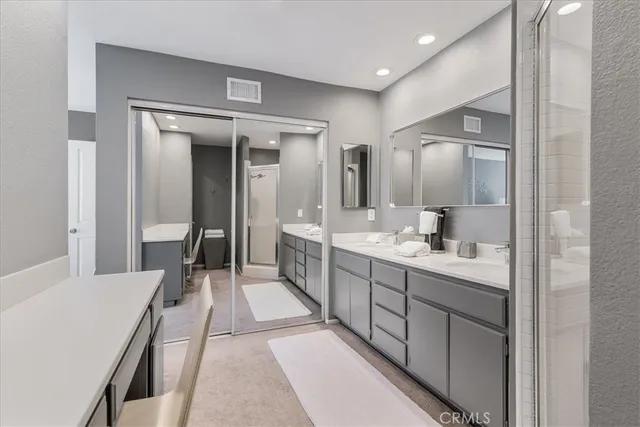 a large bathroom with a double vanity sink and mirror