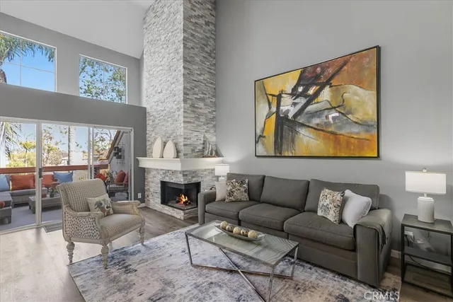 a living room with furniture a fireplace and a painting on the wall