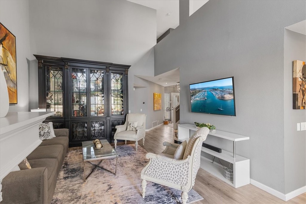 4 Logo Vista Dana Point, CA 92629 - Photo 9 of 44 a living room with furniture two large window and a flat screen tv