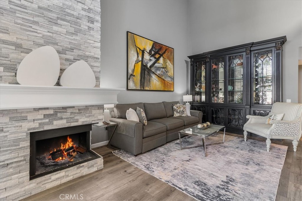 4 Logo Vista Dana Point, CA 92629 - Photo 10 of 44 a living room with furniture a rug and a fireplace