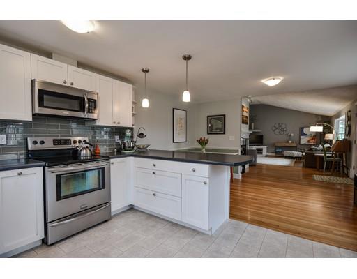 897 Salem End Road Framingham, MA 01702 - Photo 11 of 27 a kitchen with stainless steel appliances granite countertop a stove a sink a microwave a refrigerator and white cabinets with wooden floor