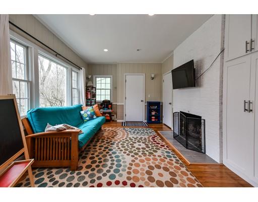 897 Salem End Road Framingham, MA 01702 - Photo 18 of 27 a living room with furniture a flat screen tv and a fireplace